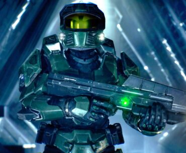 Master Chief wearing green tactical armor and a gold visor, holding a futuristic assault rifle inside a glowing blue geometric corridor structure.
