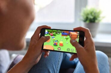 Woman playing video game on her smartphone