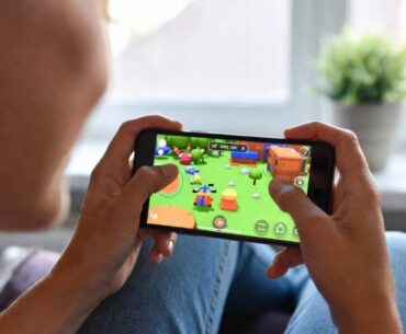 Woman playing video game on her smartphone