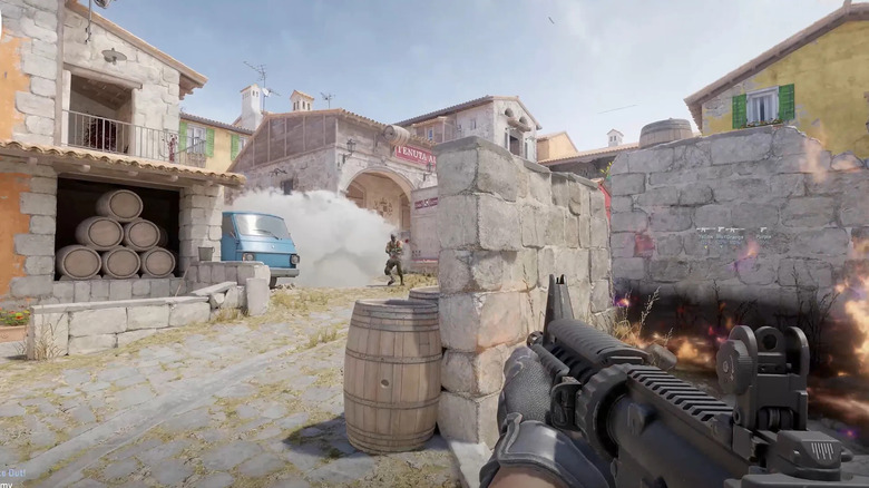 A player points a machine gun at a terrorist emerging from smoke in Counter-Strike 2