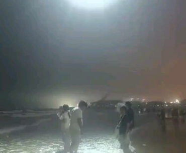 In coastal China, police deploy drones at night to warn swimmers to stay out of the sea during high tide