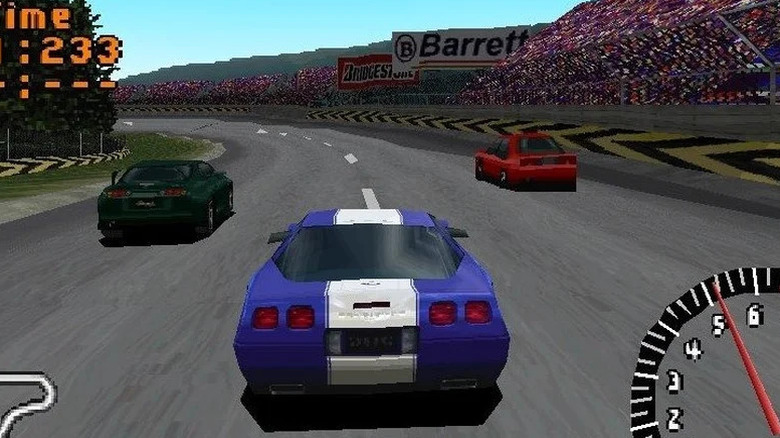 A blue race car approaches two rivals around a corner in 