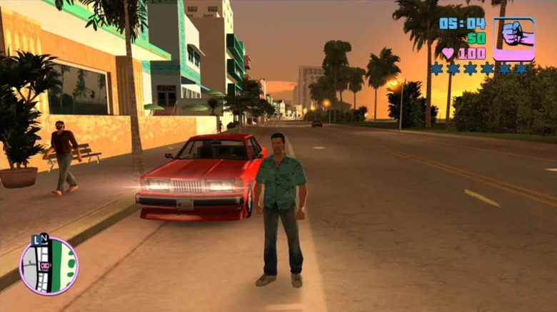 Tommy Vercetti stands by a red car in the street in Grand Theft Auto: Vice City