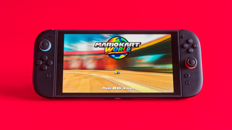 Nintendo Switch 2 running Mario Kart World in front of red background