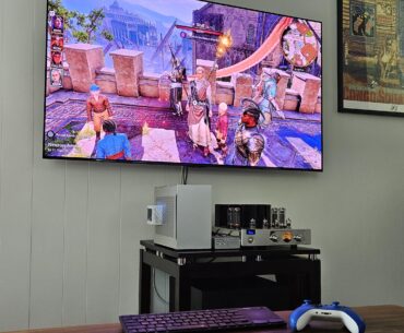 Living room battlestation — SFF PC into a tube amp, on a 65" OLED. Gaming and hifi in one.