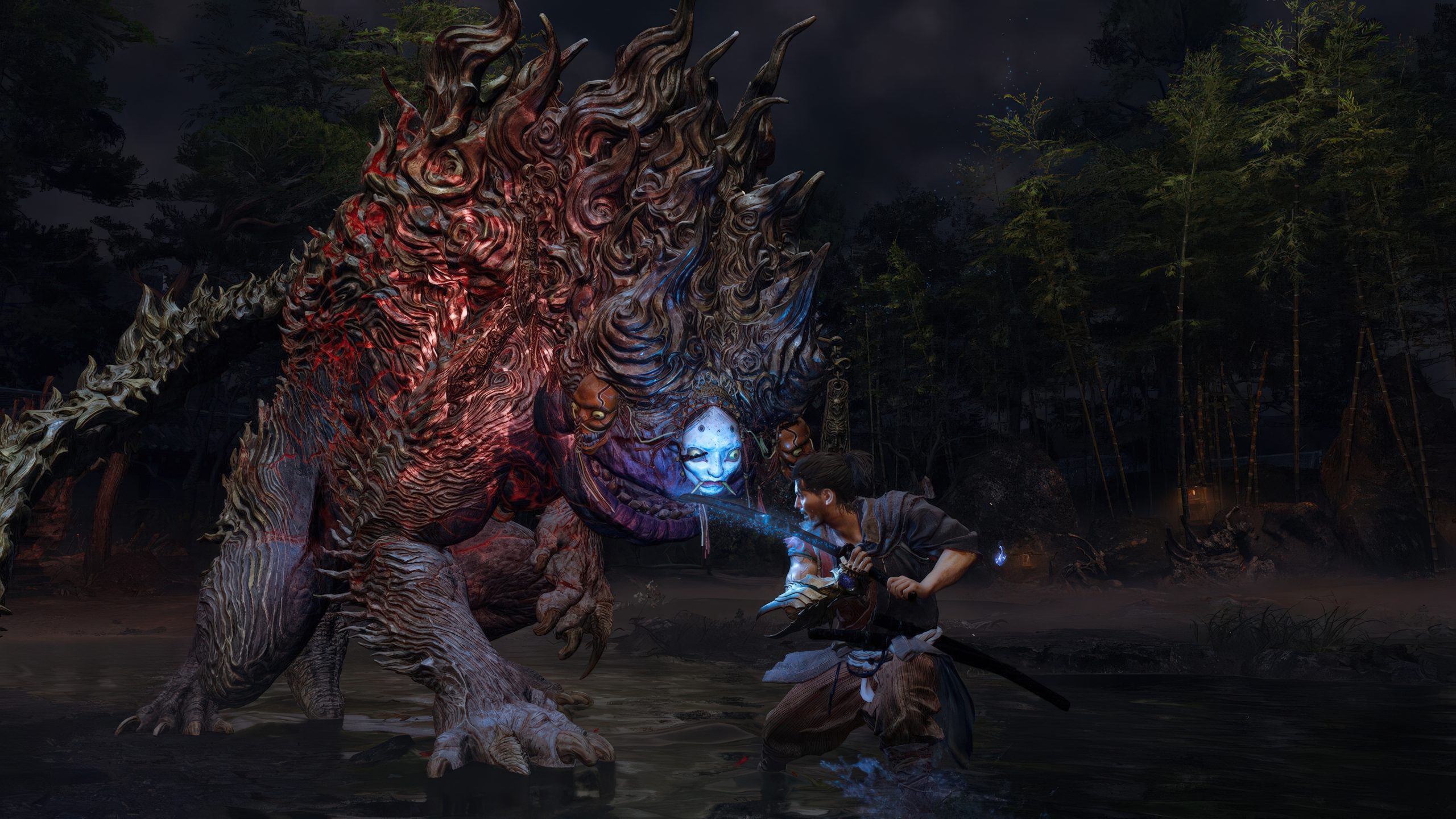 A character from the game Wo Long: Fallen Dynasty battles a large, menacing creature with a mask-like face in a dark forest setting.