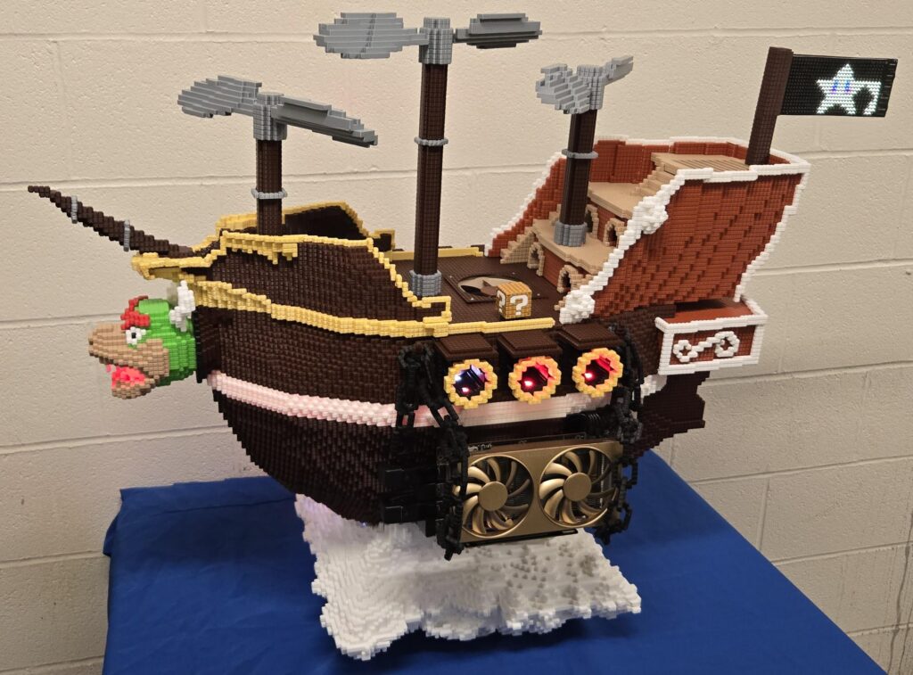 My gaming pc: The Bowser Airship! Fully 3D printed, hangs from the ceiling, propellers spin, and the gpu is being "stolen".