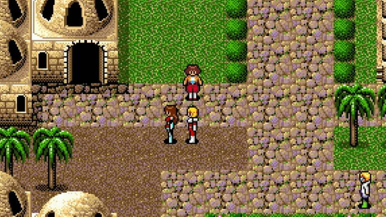 Three characters walk through a desert village together in 