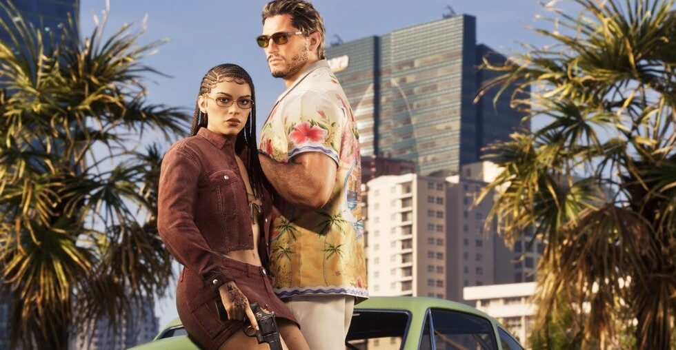 Screenshot from Grand Theft Auto 6. Jason Duval and Lucia Caminos stand together in front of palm trees and a modern cityscape. Lucia wears a cropped rust-colored jacket and glasses, with her hair in braids. Jason, wearing sunglasses and a tropical-print shirt, stands slightly behind and to her right.