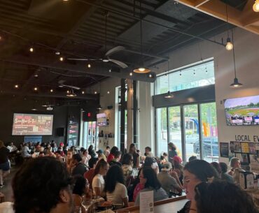 Fans gather at Two Locals to watch the first-ever Women's Pro Baseball League game on Saturday.