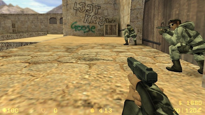 Three soldiers huddle by a large wooden door in Counter-Strike