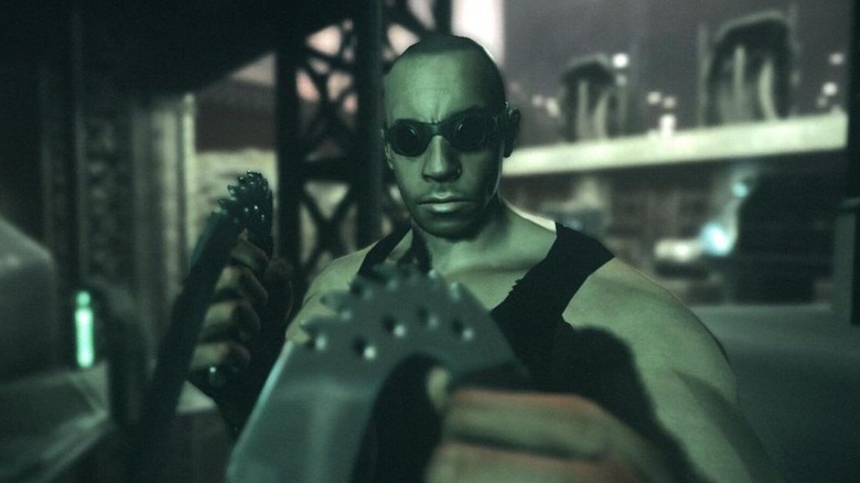 Richard B. Riddick holds two bladed weapons in The Chronicles of Riddick: Assault on Dark Athena