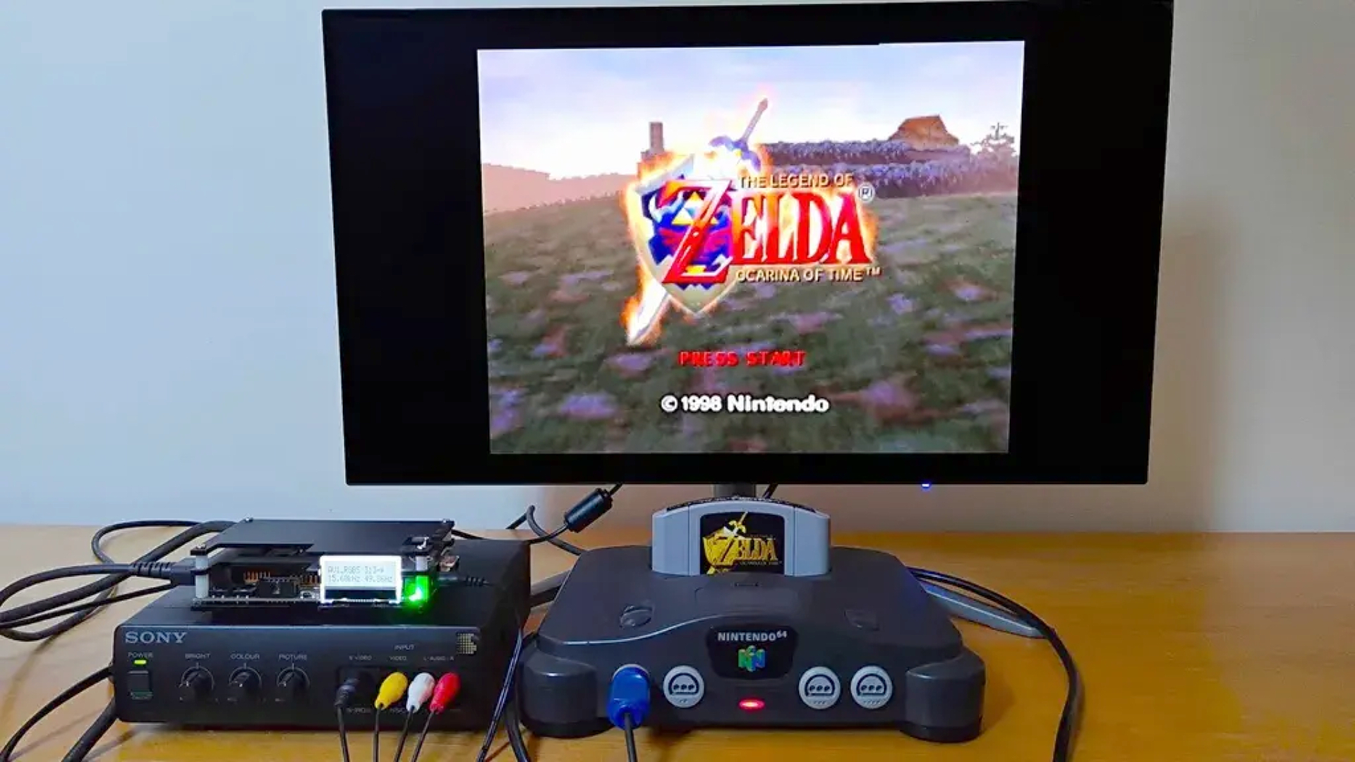 N64 connected to OSSC via Sony transcoder to KTC OLED monitor with Zelda Ocarina of Time intro on screen.